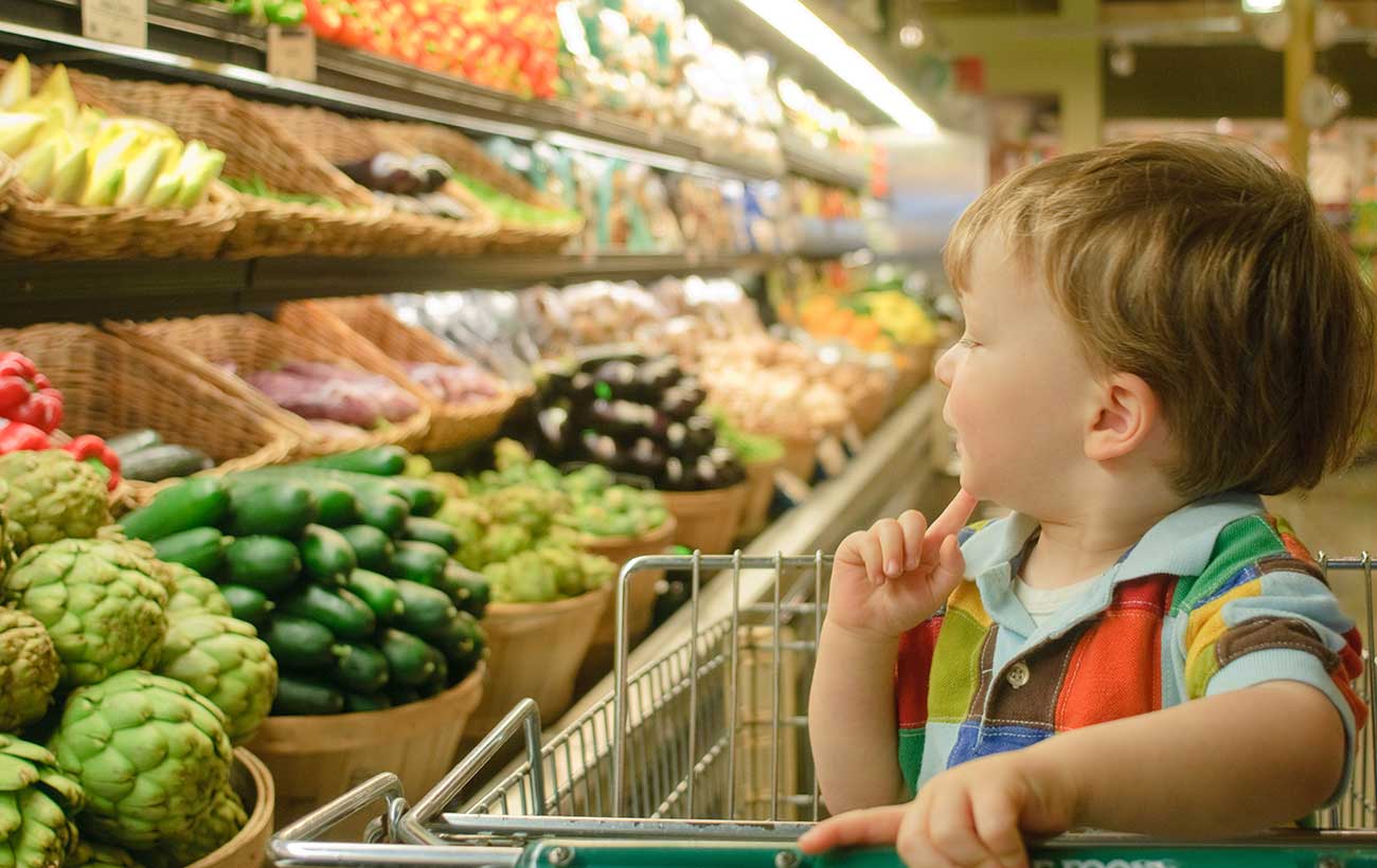 Boy Looking at Produce.