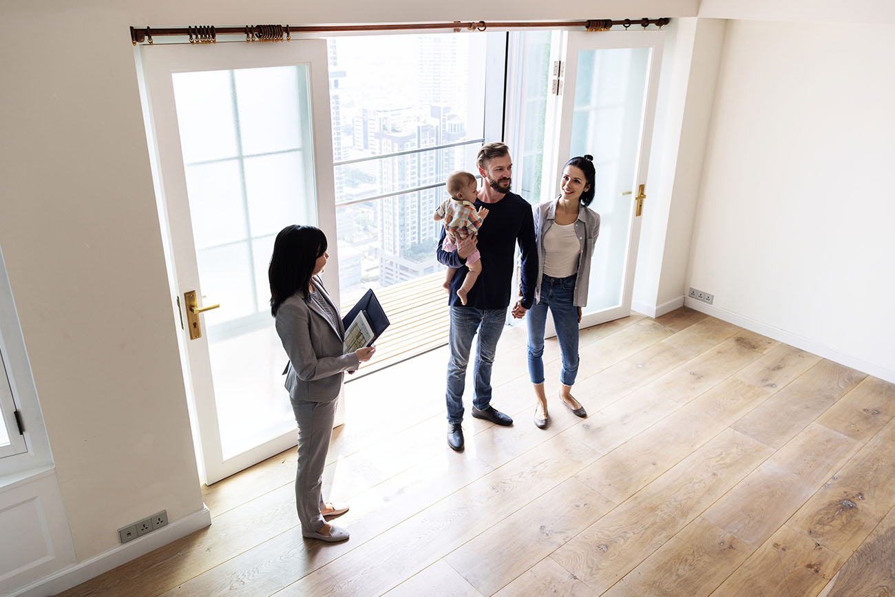 Realtor showing family around property