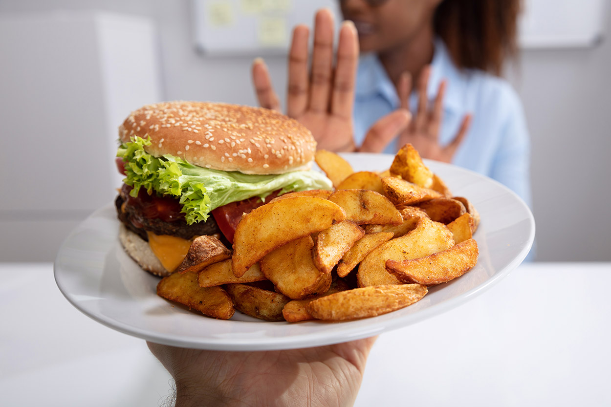 Woman refusing a burger