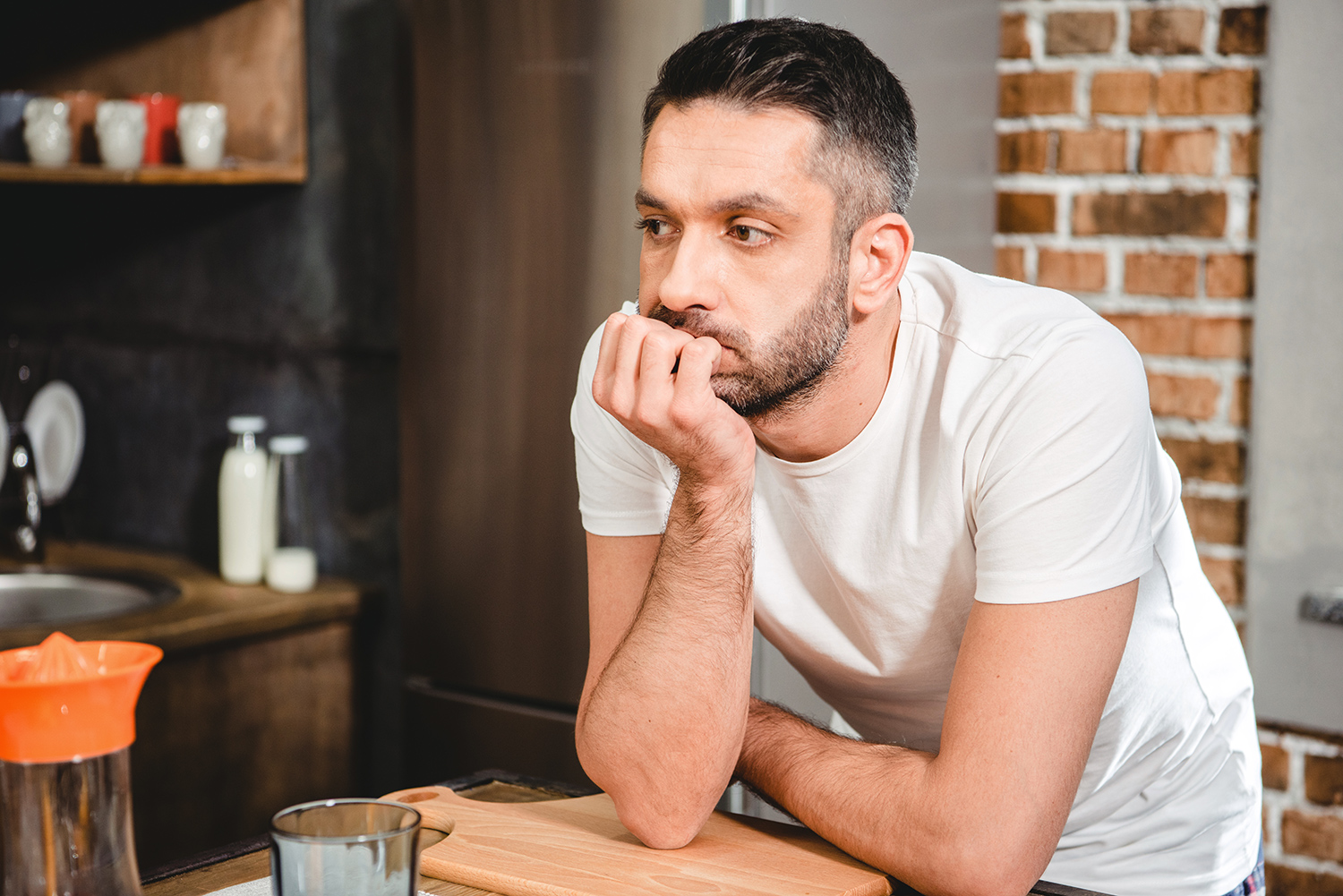 Thoughtful Man Standing in the Kitchen.